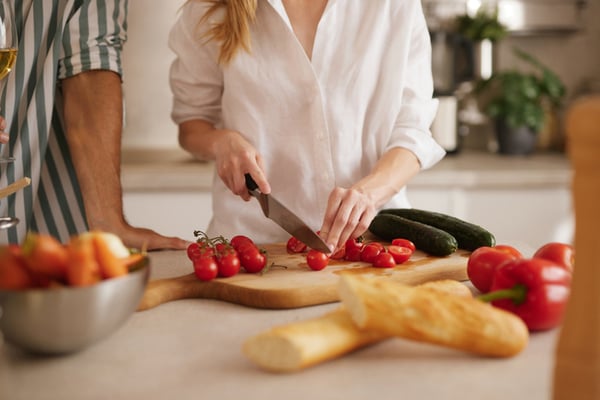 Couple preparing healthy meal together in kitchen stock photo