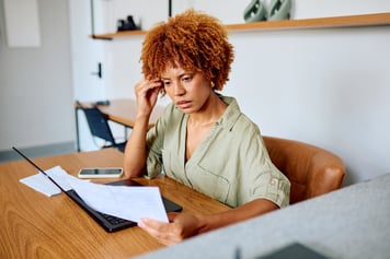 young woman at computer working, virtual mental health 
