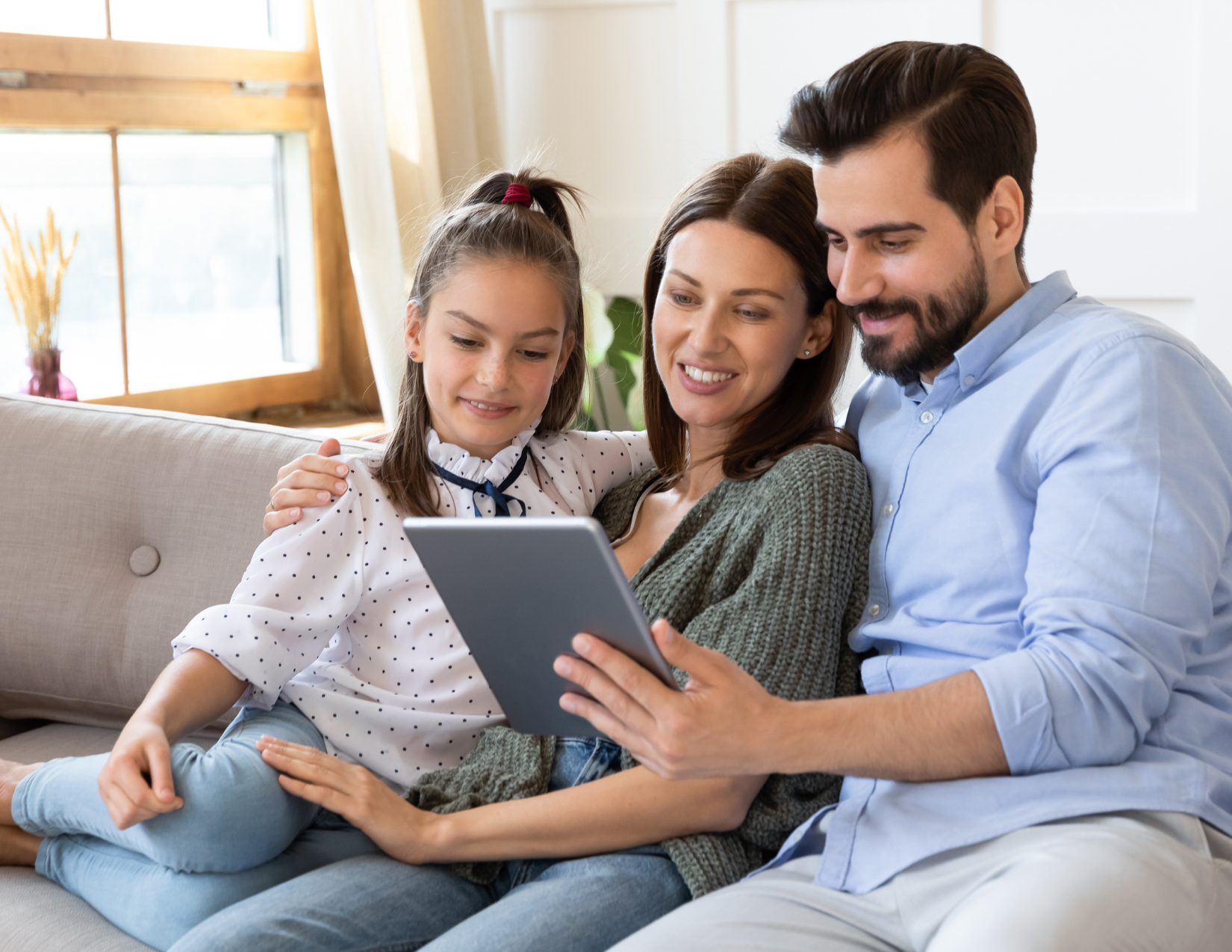 Family of father mother and daughter speaking on tablet video call