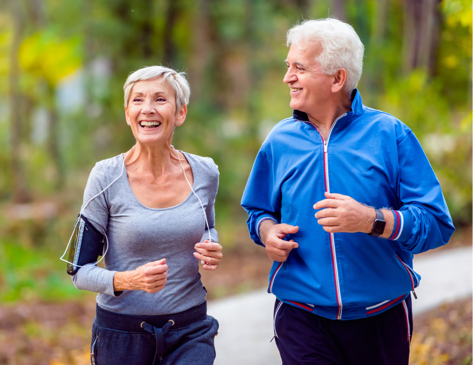 man and a woman jogging together on a trail