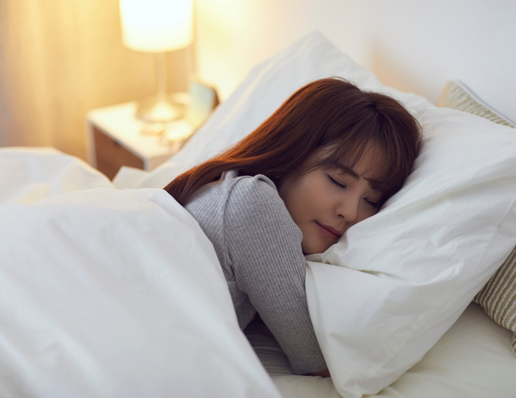 Woman sleeping in her bed